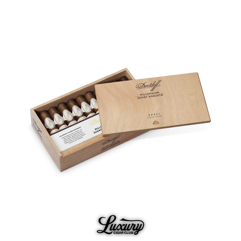 Box of Davidoff Millennium Short Robusto cigars with white and gold bands, displayed in an open light wood box with a sliding lid.