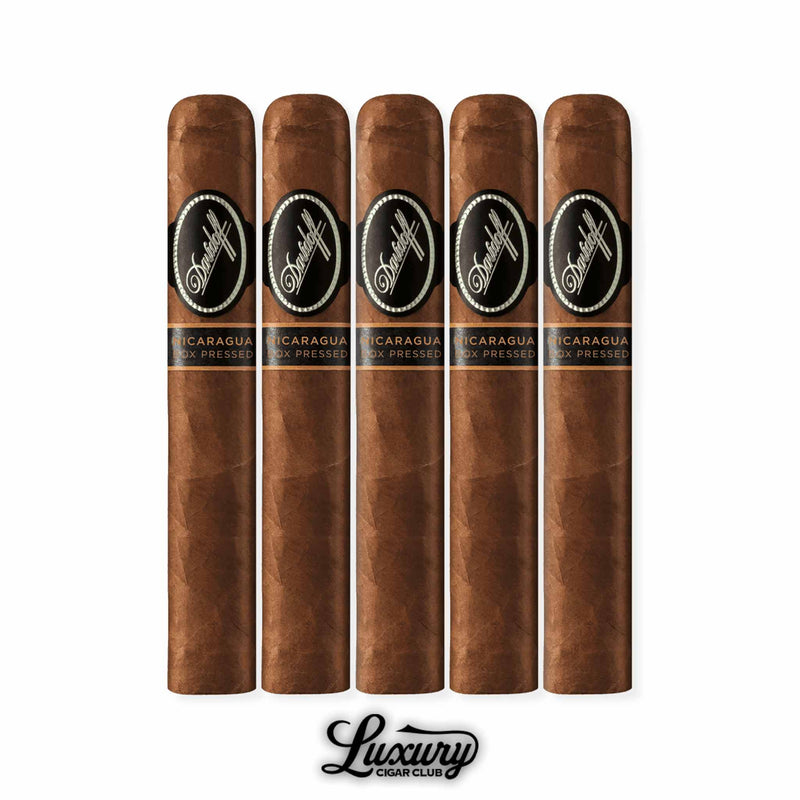 Five box-pressed Davidoff Nicaragua Robusto cigars lined together, each showcasing a sharp-edged square press, bold black bands with silver accents, and secondary Nicaragua designation. Premium presentation is completed with the Luxury Cigar Club logo.