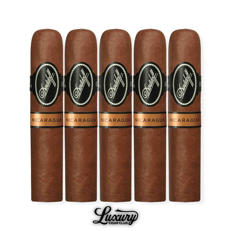 A premium 5-pack of Davidoff Nicaragua Short Corona cigars, with copper Nicaragua secondary bands and black Davidoff branding, arranged upright above the Luxury Cigar Club logo.