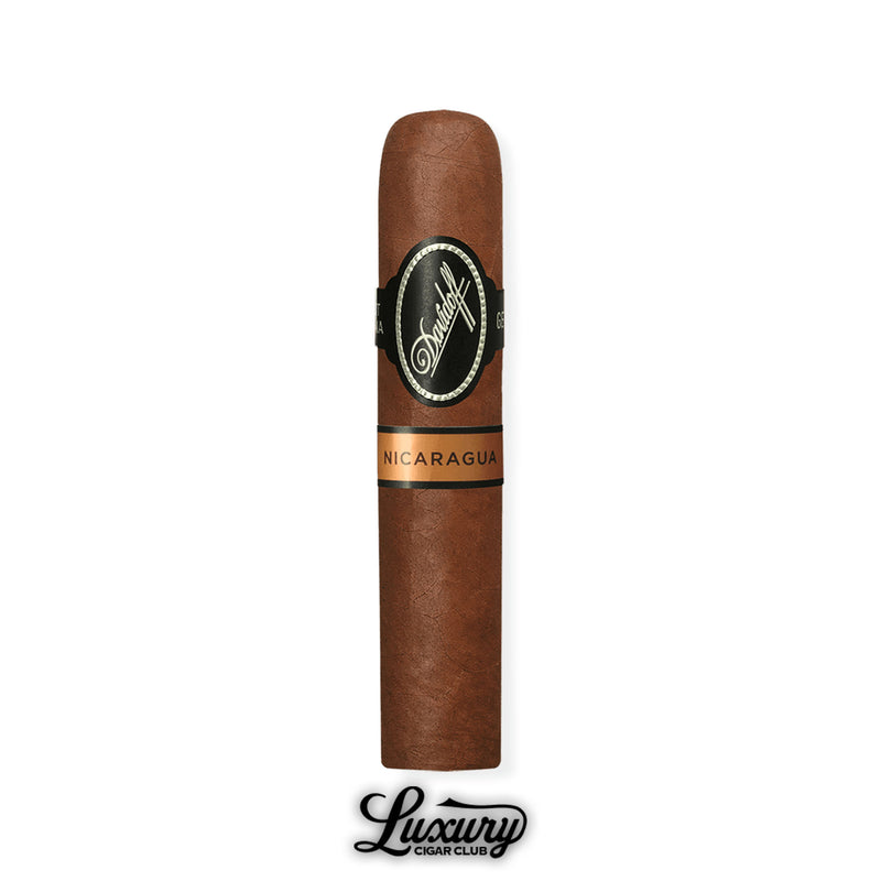 A single Short Corona from the Davidoff Nicaragua line, standing upright with black and copper dual bands, photographed with the Luxury Cigar Club logo below.