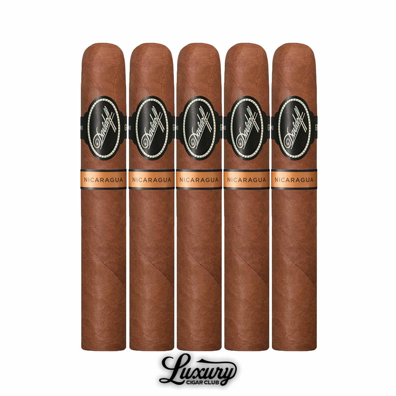 Five Davidoff Nicaragua Toro cigars arranged side by side, smooth brown wrappers with dual black and copper branding bands, displayed over the Luxury Cigar Club logo.
