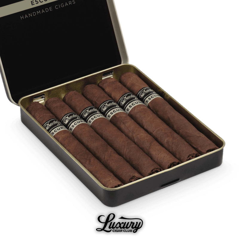 Open tin of Davidoff Primeros Escurio handmade cigars with black and silver branding, featuring seven dark-wrapped cigars from Luxury Cigar Club.
