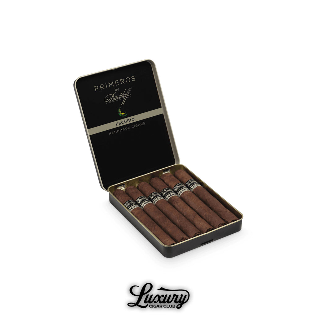 Open tin of Davidoff Primeros Escurio handmade cigars with black and silver branding, featuring seven dark-wrapped cigars from Luxury Cigar Club.