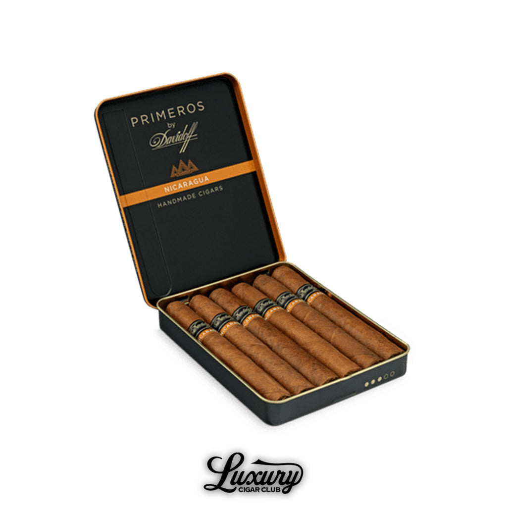 Open tin of Davidoff Primeros Nicaragua handmade cigars with visible branding and orange accent, displayed on white background