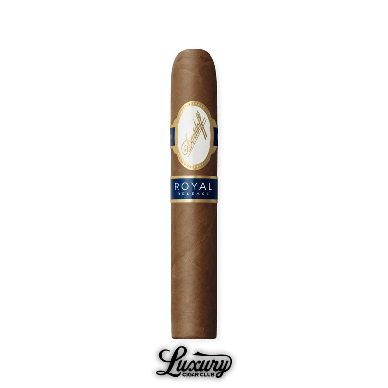 Single Robusto cigar with straight body and rounded head, natural brown wrapper leaf, finished with Davidoff white-and-gold band and navy blue “Royal Release” label, Luxury Cigar Club logo shown at bottom.