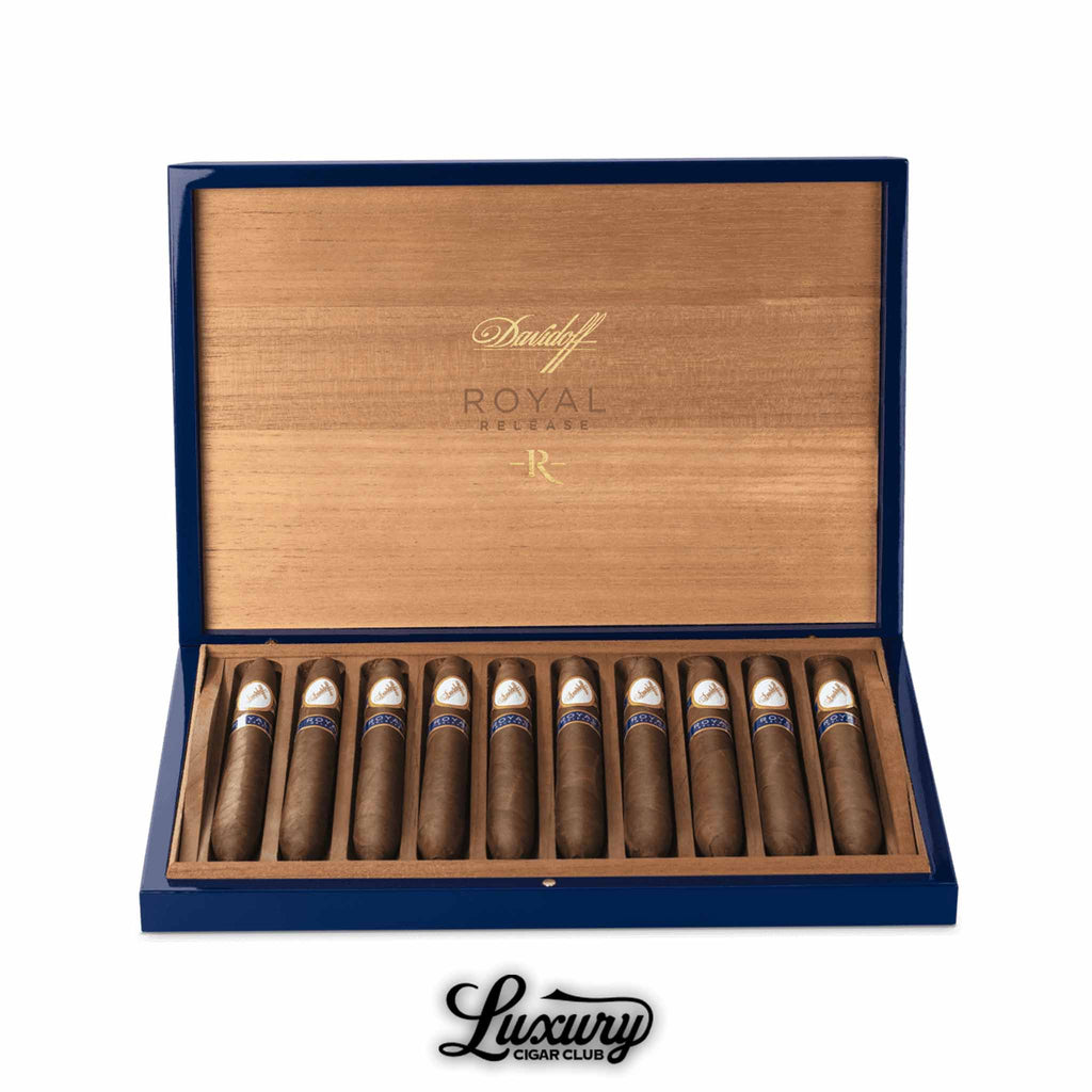 Open blue and wood Davidoff Royal Release box displaying twelve Salomone cigars with tapered ends, each banded in white and gold with a blue “Royal Release” label, Luxury Cigar Club logo at bottom.