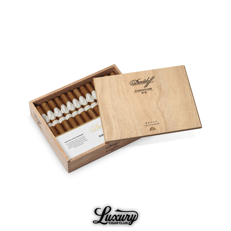 f Signature No. 2 Cigars
Alt text: Davidoff Signature No. 2 cigars displayed inside an open cedar box, slim vitolas lined up with elegant white and gold bands, lid engraved with Davidoff branding, Luxury Cigar Club logo at bottom.