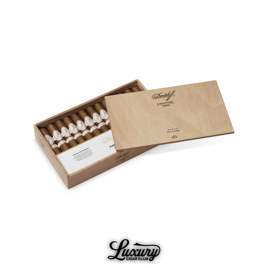 Open wooden box of Davidoff Signature Toro cigars neatly arranged in rows, each with white and gold bands, partially covered by the branded lid, with Luxury Cigar Club logo beneath.