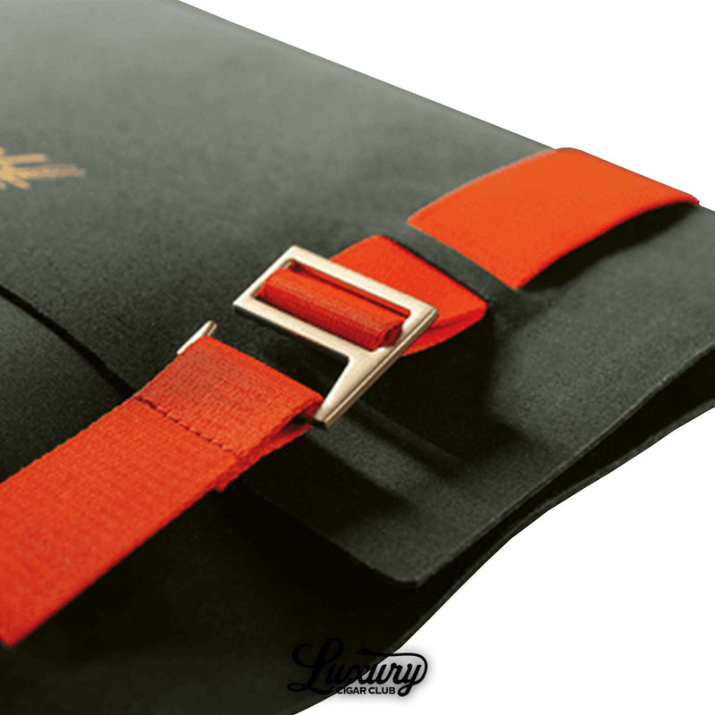 Close-up of the Davidoff Travel Humidor Explorer showing the fine stitching, durable black material, and striking orange straps secured with gold buckles. Highlights the humidor’s sophisticated design and attention to detail. Luxury Cigar Club.