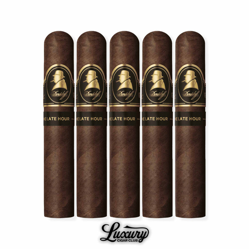 Five Davidoff Winston Churchill Late Hour Robusto cigars with dark brown wrappers, each featuring a black and gold band with Winston Churchill’s silhouette, arranged in a row with the Luxury Cigar Club logo displayed below.