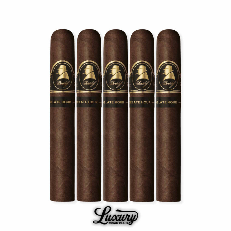 Five Davidoff Winston Churchill Late Hour Toro cigars, medium-to-large format, with rich dark wrappers and elegant black and gold Churchill bands, neatly lined up in a row with the Luxury Cigar Club logo beneath.