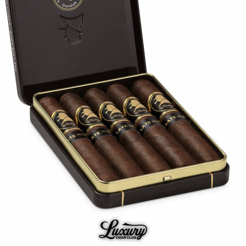 Close-up of Davidoff Winston Churchill The Late Hour Petit Panetela cigars in a black tin, showing detailed cigar bands and rich wrappers.