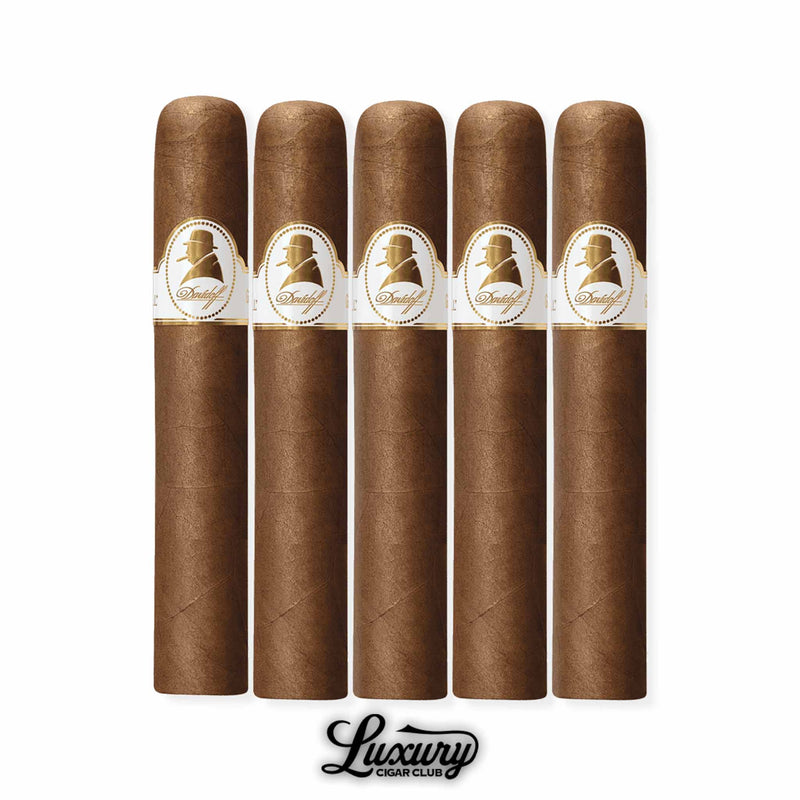 Five Davidoff Winston Churchill The Original Series Robusto cigars arranged side by side in a 5-pack, showcasing medium brown Ecuadorian wrappers with white and gold Davidoff Churchill bands, presented by Luxury Cigar Club.