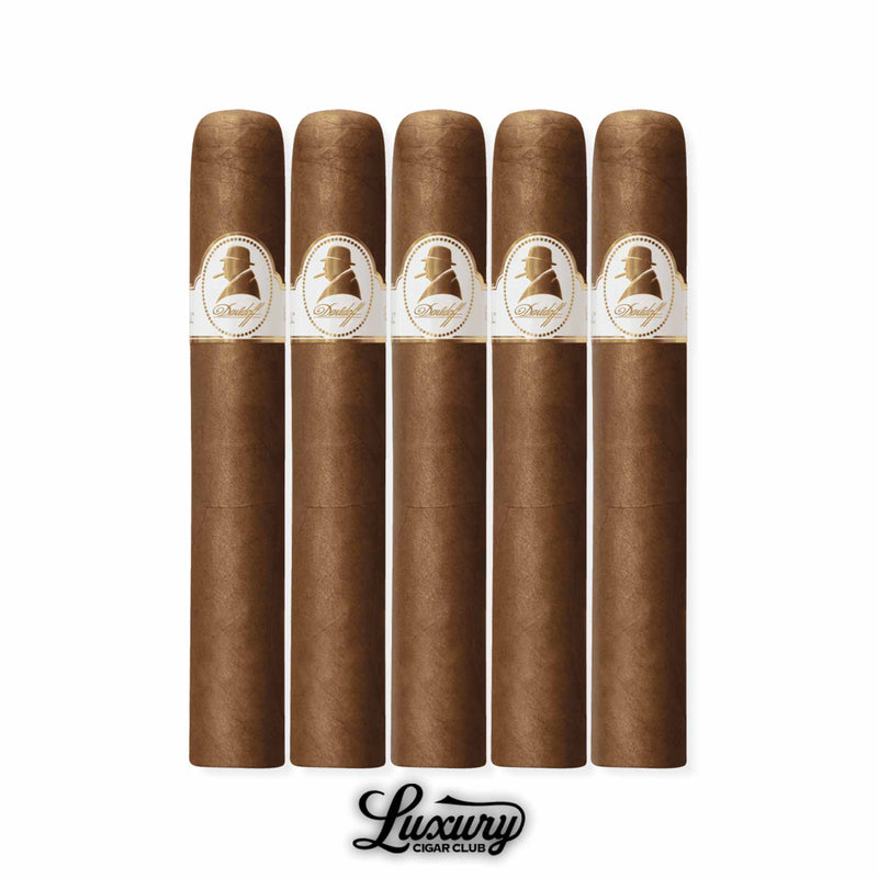 Set of five Davidoff Winston Churchill The Original Series Toro cigars in a 5-pack, crafted with Ecuadorian wrapper and Dominican blend, each cigar adorned with the signature white and gold Churchill band, displayed by Luxury Cigar Club.