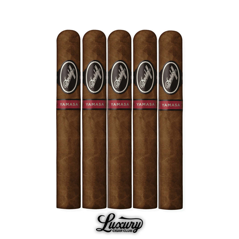 Five Davidoff Yamasa Toro cigars in a row, wrapped in deep brown leaf with glossy finish, each adorned with the black Davidoff oval band and red Yamasa band, accompanied by the Luxury Cigar Club logo beneath.