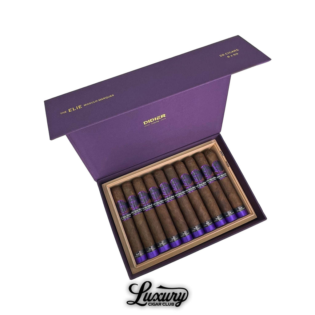 Open purple box of Didier Elie Modulo Marques cigars, neatly arranged in two rows with dark brown wrappers and purple foot bands, displayed by Luxury Cigar Club.