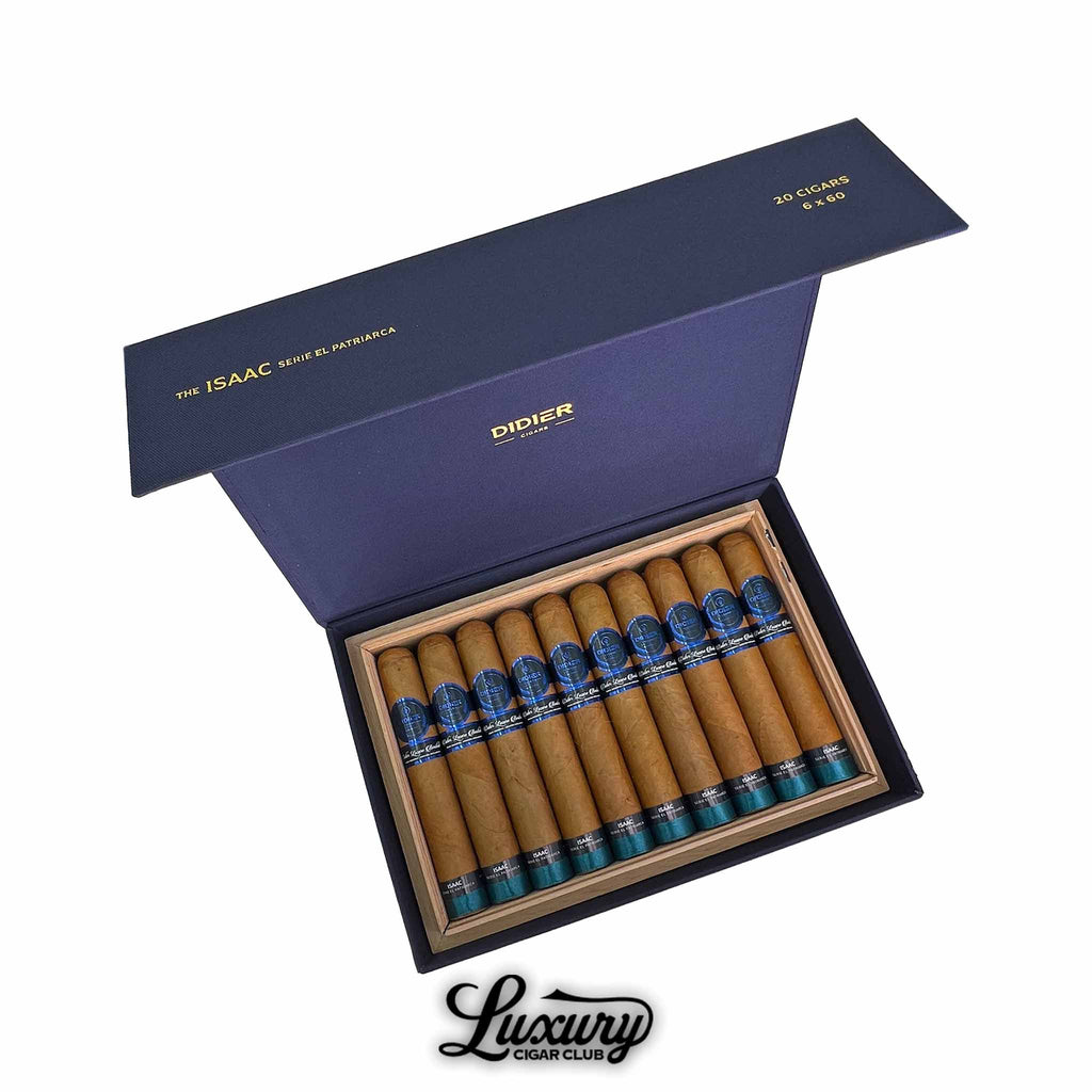 Open navy blue box of Didier Isaac Serie El Patriarca cigars, featuring light brown wrappers with blue and black bands, arranged neatly in a cedar-lined box.