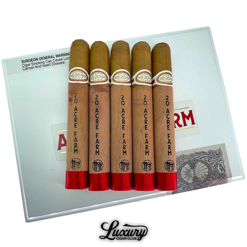 Five Drew Estate 20 Acre Farm Toro cigars displayed on top of the white box lid. The cigars are wrapped in cedar sleeves with red foil feet and gold embossed bands. Luxury Cigar Club logo below.