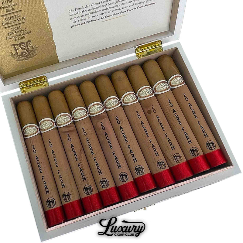 Close-up of Drew Estate 20 Acre Farm Toro cigars in a white box with blend information printed inside the lid. Each cigar is wrapped in cedar with black logo print and red foot bands. Luxury Cigar Club logo beneath.