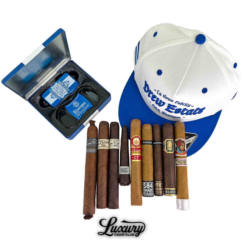 Drew Estate Collectors Dream Sampler featuring premium cigars, Drew Estate branded hat, and cigar accessories from Luxury Cigar Club.