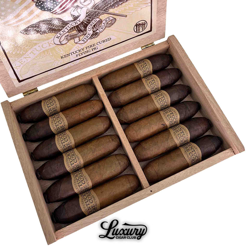 Close-up of Drew Estate Kentucky Fire Cured Flying Pig cigars showing dark, oily wrappers and signature rustic bands, presented by Luxury Cigar Club.