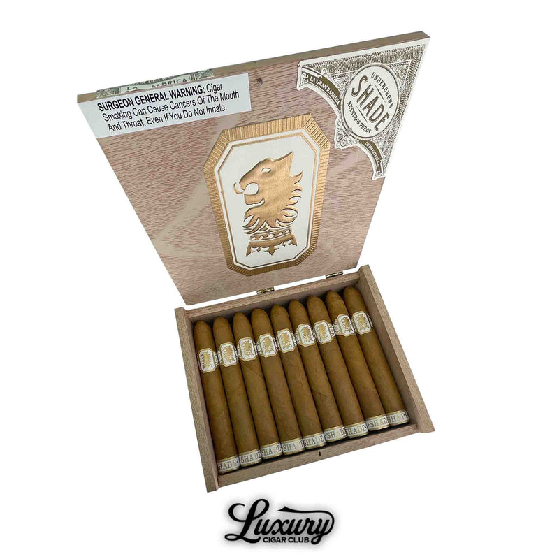 Drew Estate Undercrown Shade Belicoso cigars in an open box, revealing expertly rolled Connecticut Shade cigars with a classic golden lion motif, featured by Luxury Cigar Club.