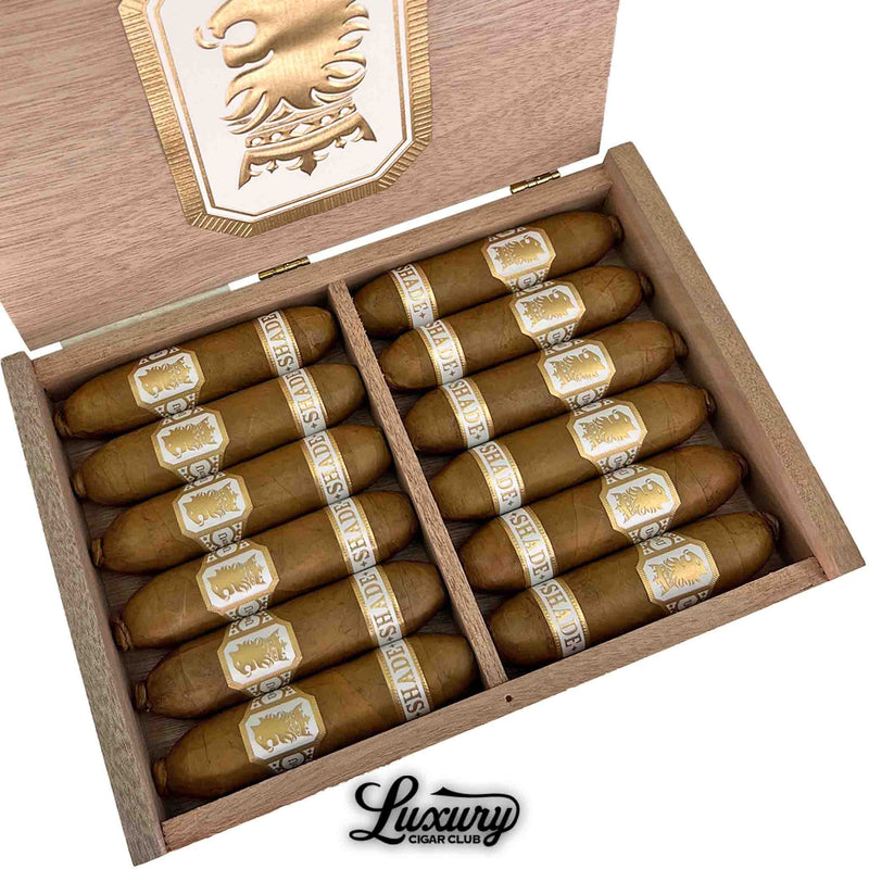Close-up of Drew Estate Undercrown Shade Flying Pig cigars inside a wooden box showcasing creamy golden bands, featured by Luxury Cigar Club.