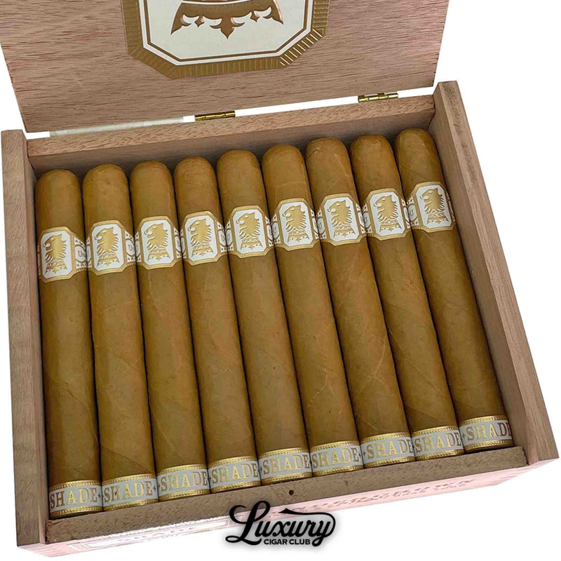 Close-up of Drew Estate Undercrown Shade Gran Toro cigars highlighting the flawless golden wrapper and elegant cream-and-gold branding, featured by Luxury Cigar Club.