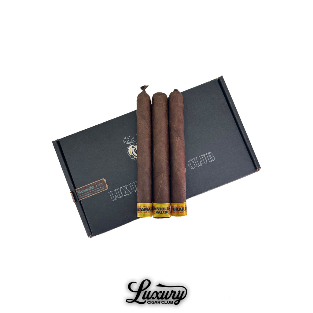Dunbarton Tobacco & Trust Samples of Saka cigar sampler featuring three dark-wrapped cigars on a black Luxury Cigar Club box.