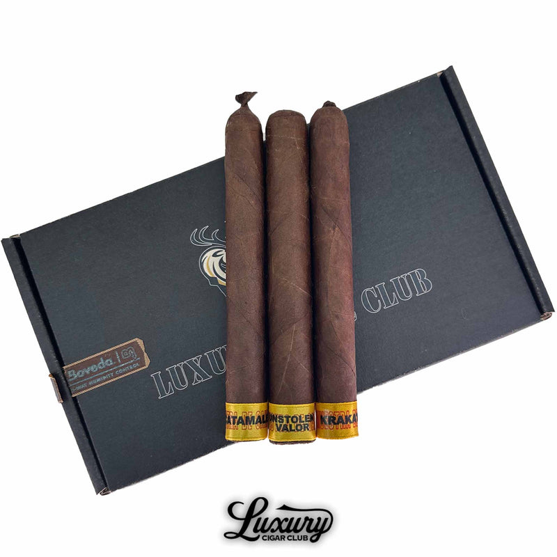 Close-up of Dunbarton Tobacco & Trust Samples of Saka cigars with twisted caps and gold foot bands, displayed on a Luxury Cigar Club box.