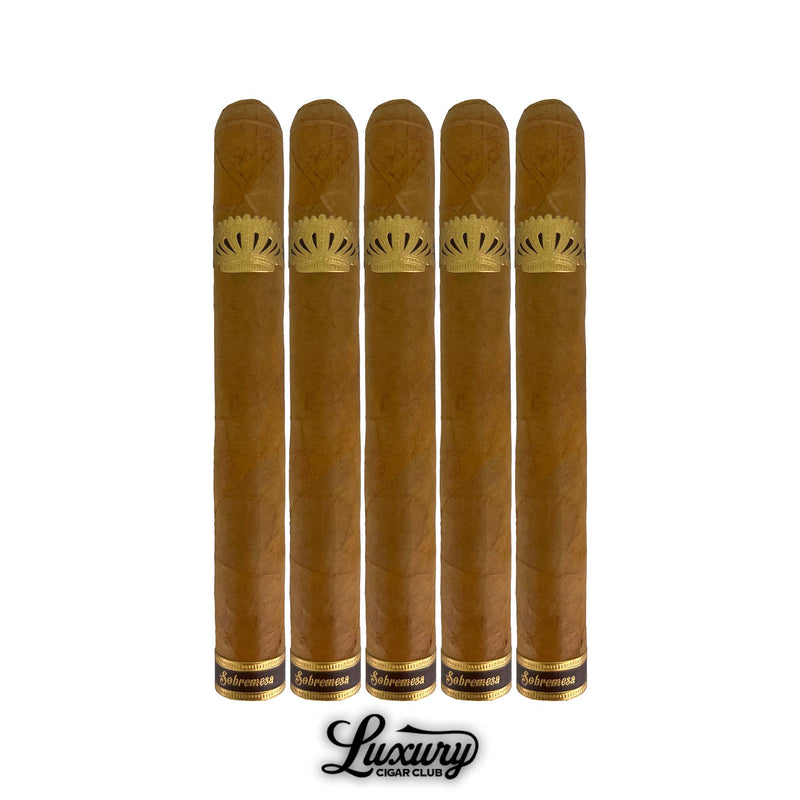 Five Dunbarton Tobacco & Trust Sobremesa Brûlée Double Corona cigars lined up, showing golden Connecticut Shade wrappers and refined gold crown bands. Luxury Cigar Club logo below.