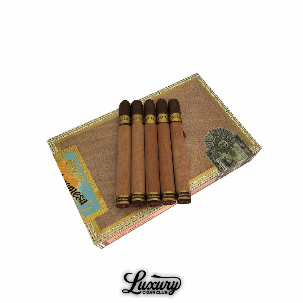 Box of Dunbarton Tobacco & Trust Sobremesa Solita El Americano cigars with five cedar wrapped cigars placed on top showing brown caps and gold embossed bands, displayed for sale at Luxury Cigar Club.