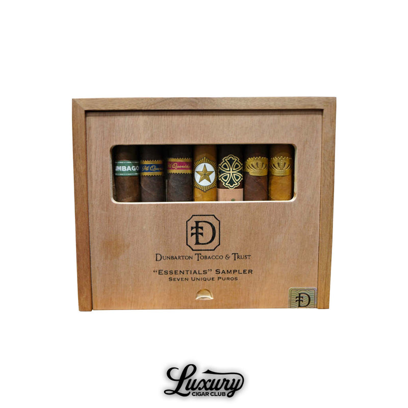 Dunbarton Tobacco and Trust Essentials Sampler displayed in a natural wooden box with a clear window showcasing seven premium cigars, including Umbagog, Mi Querida, Mi Querida Triqui Traca, StillWell Star, Sin Compromiso, Sobremesa, and Sobremesa Brûlée, photographed on a white background for Luxury Cigar Club.