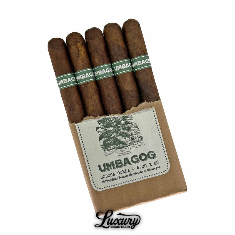 Dunbarton Tobacco & Trust Umbagog Corona Gorda Cigars Open Pack. Partially opened brown paper bundle showing five Umbagog Corona Gorda cigars with dark brown wrappers and green-gold bands, handmade in Nicaragua.