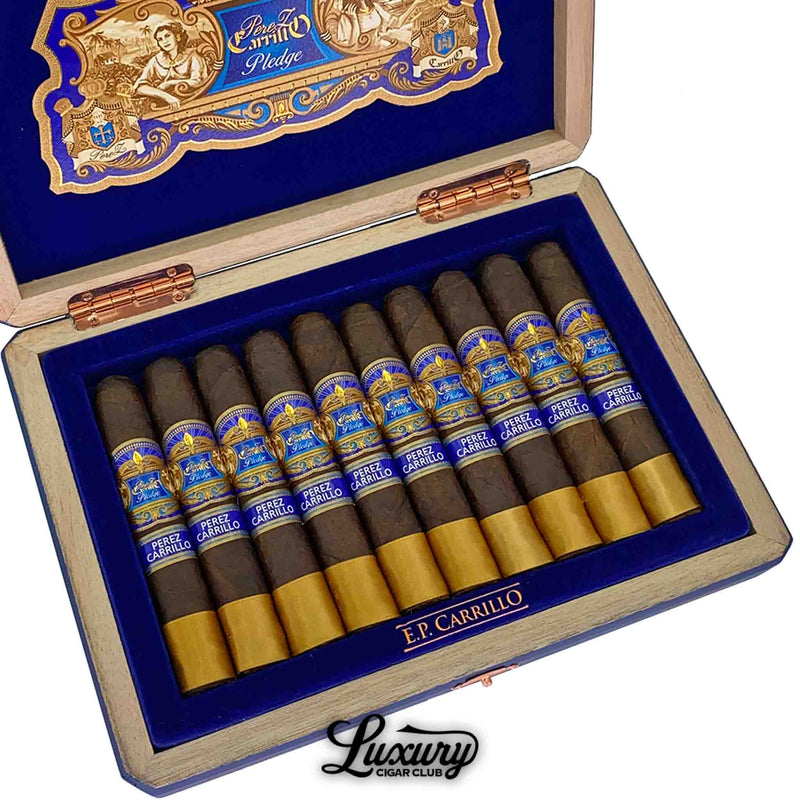 Close up view of EP Carrillo Pledge cigars inside blue velvet box showcasing detailed gold and blue bands for Luxury Cigar Club website.
