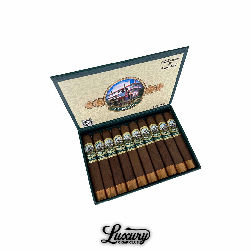 Open box of El Mago Mistico box-pressed robusto cigars, showing 10 neatly arranged cigars with foot ribbons, detailed band artwork, and interior lid branding, placed on a white background with the Luxury Cigar Club logo below.