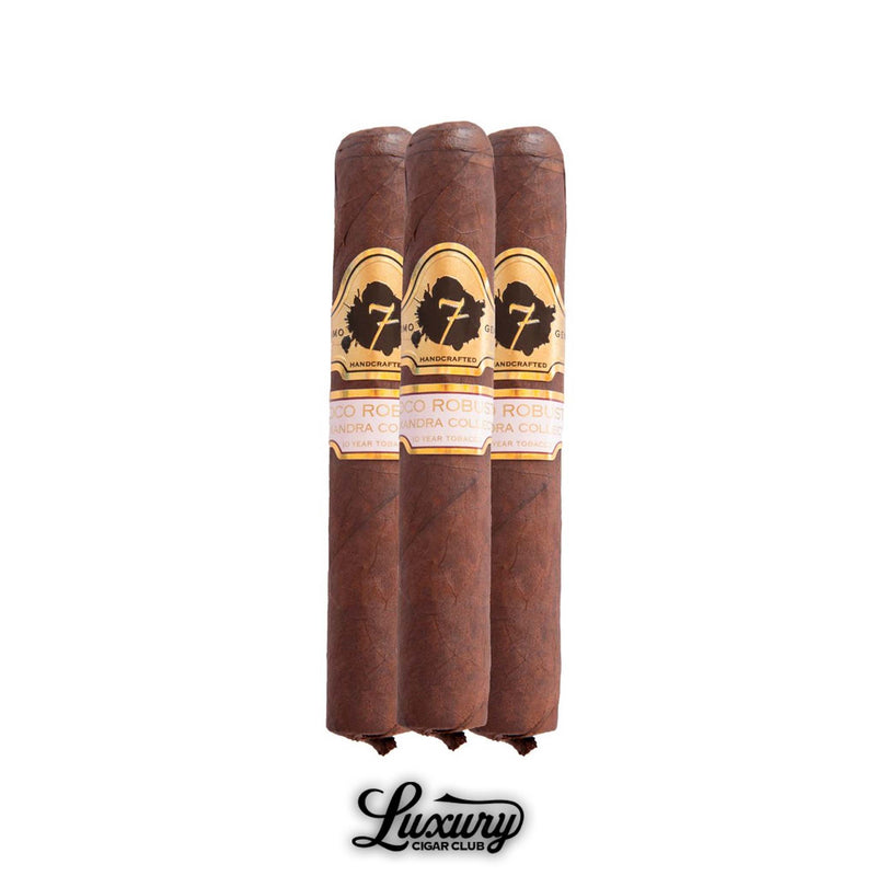 Trio of El Septimo Alexandra Collection Coco Robusto cigars with gold and black bands, offered by Luxury Cigar Club.
