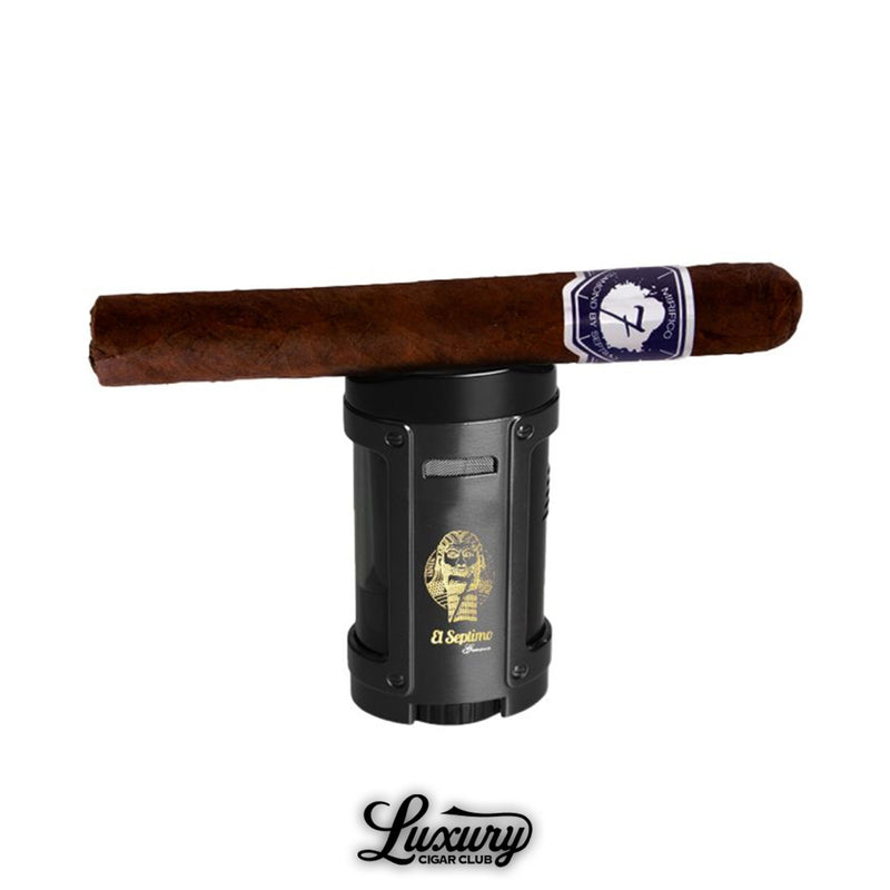 El Septimo Gilgamesh Black Quadruple Torch Lighter holding a cigar across the top featured by Luxury Cigar Club.