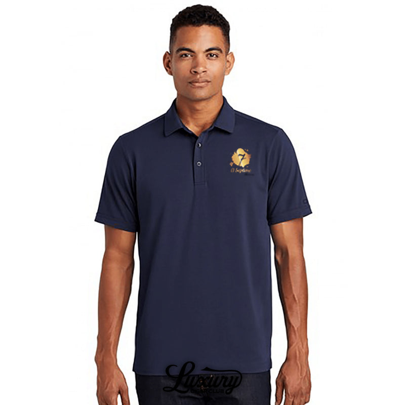 A man wearing an El Septimo OGIO men’s navy polo shirt with gold embroidered logo shown by Luxury Cigar Club.