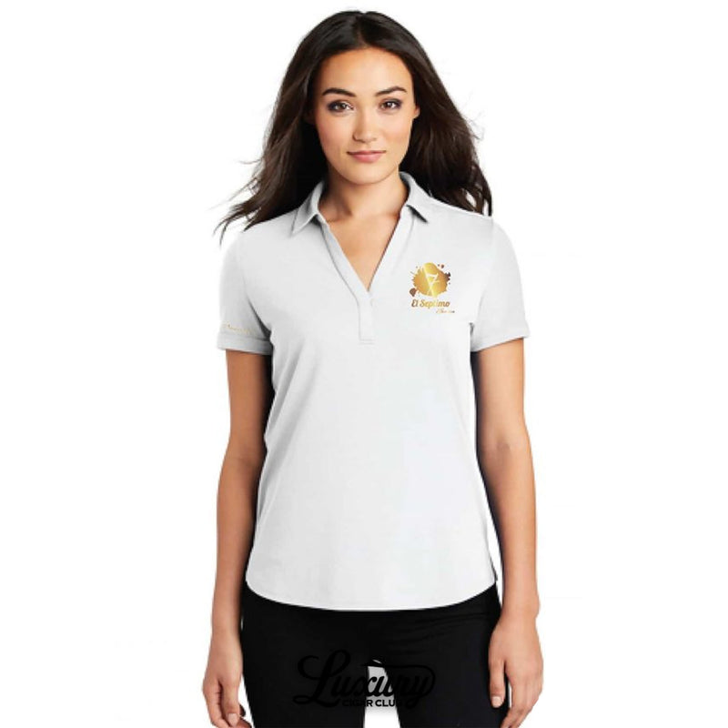 Luxury Cigar Club shows a model wearing the El Septimo OGIO women’s fitted white polo shirt with gold embroidered logo on the chest and Premium Cigars on the sleeve.