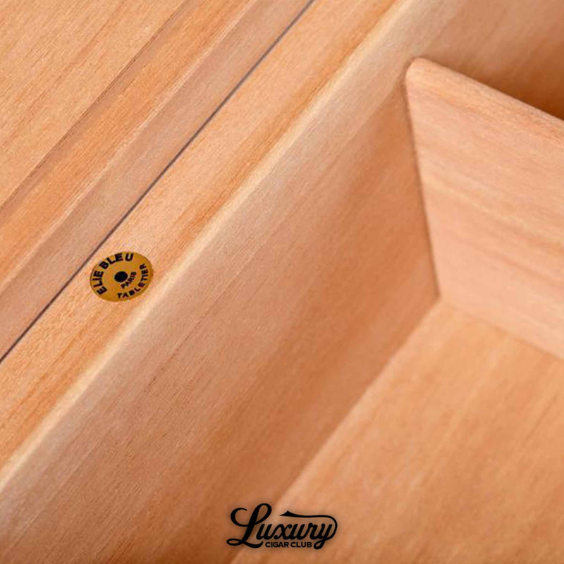 Detailed interior of Elie Bleu Classic Humidor with Blue Bleu branding and smooth cedar lining, photographed for Luxury Cigar Club.