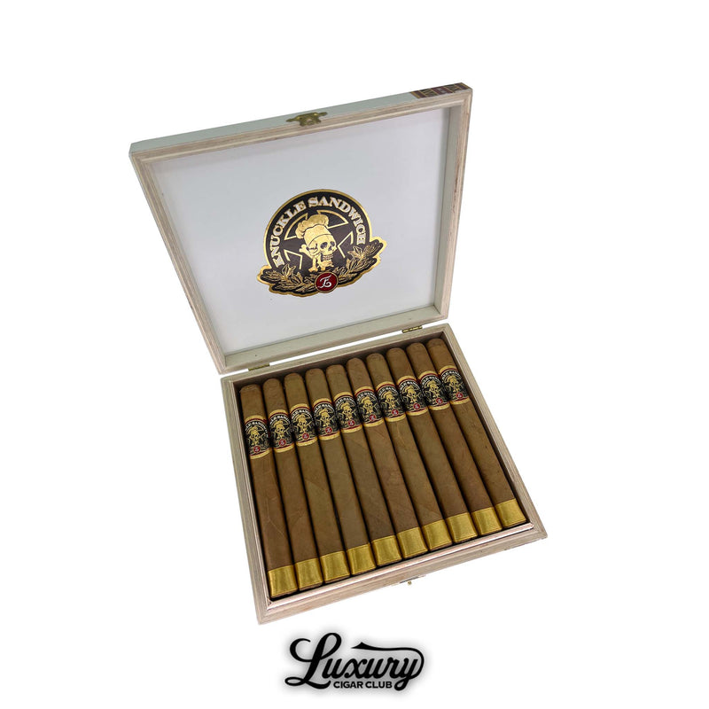 Espinosa Knuckle Sandwich Connecticut Short Churchill cigars displayed in an open white and gold box, showcasing elegant golden foot bands and skull-themed labels, presented by Luxury Cigar Club.