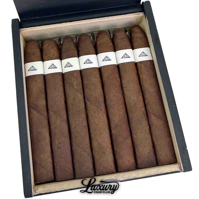Close up of Fable Fourth Prime Friday cigars resting in the open box, showing rich dark wrapper texture, box press shape and white triangle bands.