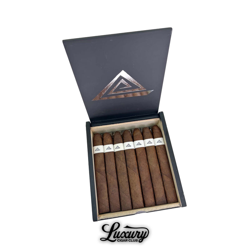 Open box of Fable Fourth Prime Friday cigars from Luxury Cigar Club, showing long box-pressed dark brown cigars with white minimalist triangle band and matte black lid interior.