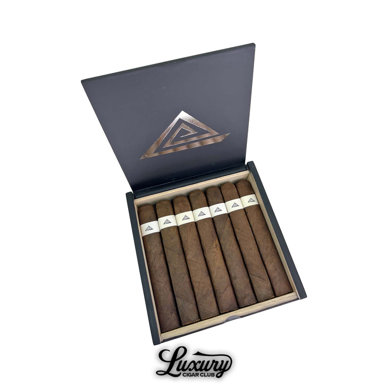 Open box of Fable Fourth Prime Machu cigars from Luxury Cigar Club, featuring long dark cigars with clean white triangle bands inside a matte black presentation box.