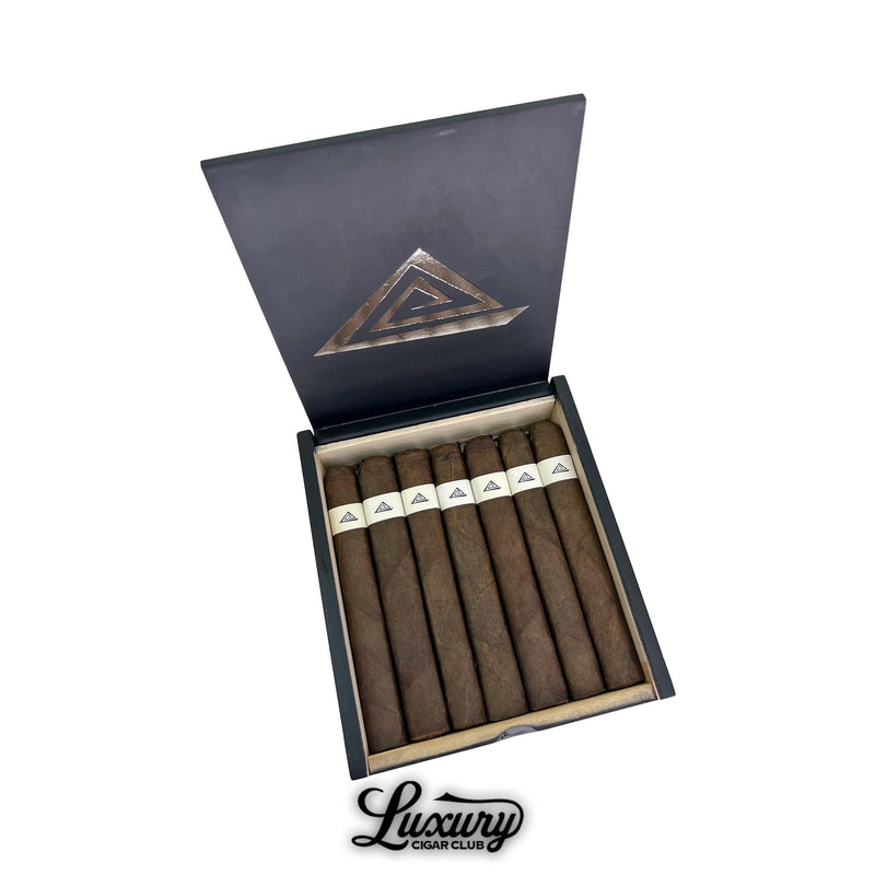 Open black Fable Fourth Prime Sapta cigar box displaying eight dark brown cigars with minimalist white bands, photographed by Luxury Cigar Club
