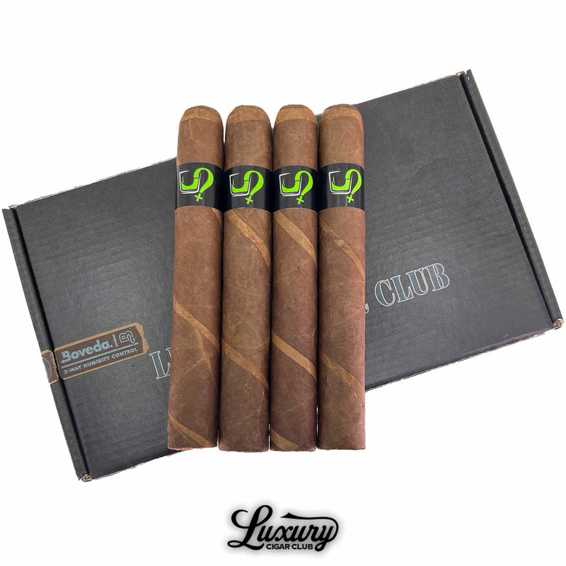 Close-up of four Fable Scion Two Things Limited Edition Toro cigars showing alternating barber pole wrappers and black cigar bands with bright green logos, resting on a Luxury Cigar Club box.
