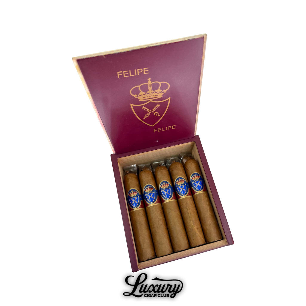 Felipe Gregorio Felipe Felipe Magnum 54 cigars displayed in an open burgundy box with gold royal crest branding, presented by Luxury Cigar Club.