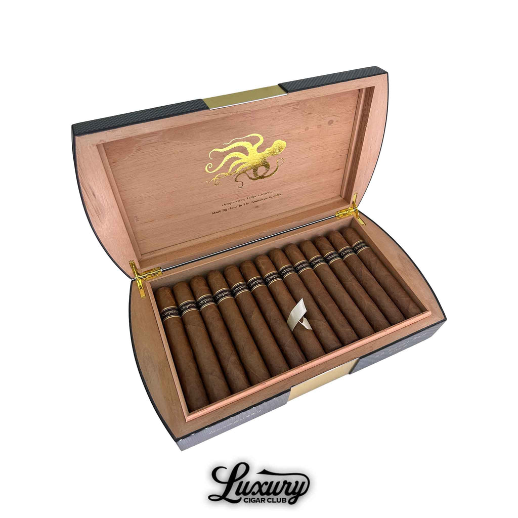 Open box of Felipe Gregorio Octopussy cigars, showcasing a luxurious curved-edge humidor with gold hinges, cedar interior, and black and gold branding, available at Luxury Cigar Club.