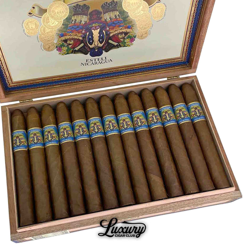 Close-up of Foundation Cigars El Güegüense The Wise Man Torpedo from Luxury Cigar Club, highlighting tapered heads, smooth brown wrappers, and detailed Nicaraguan-inspired band design.